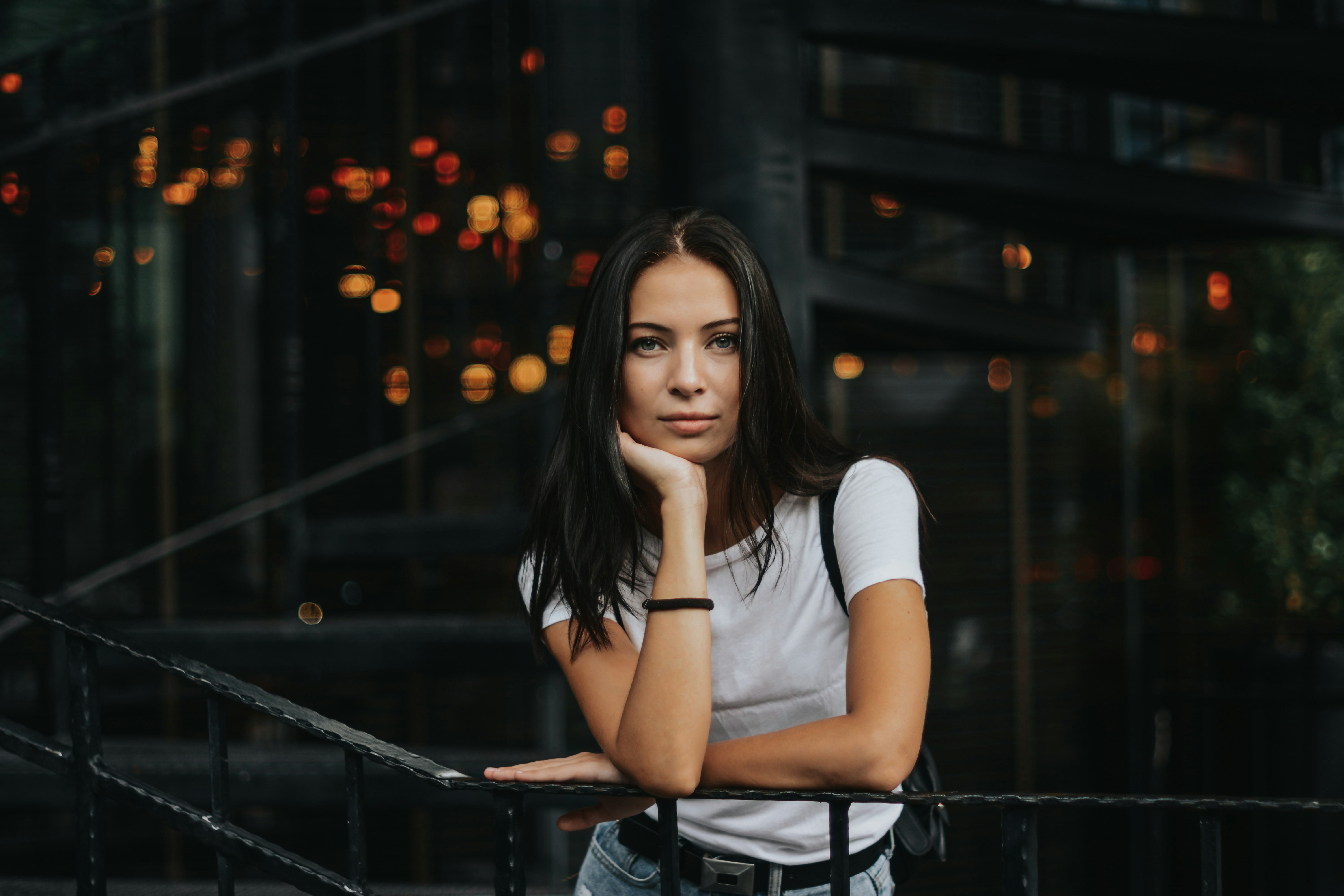 woman leaning on black handrail